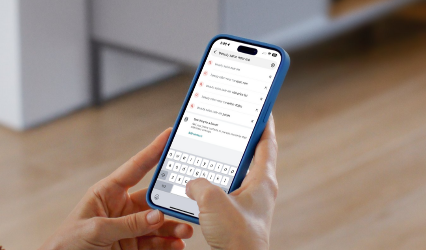 Person using a smartphone to search for “beauty salon near me” on Google, showing local SEO results for beauty businesses.