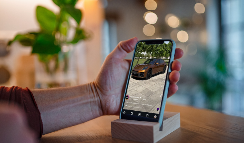 Person watching car dealership video content on smartphone