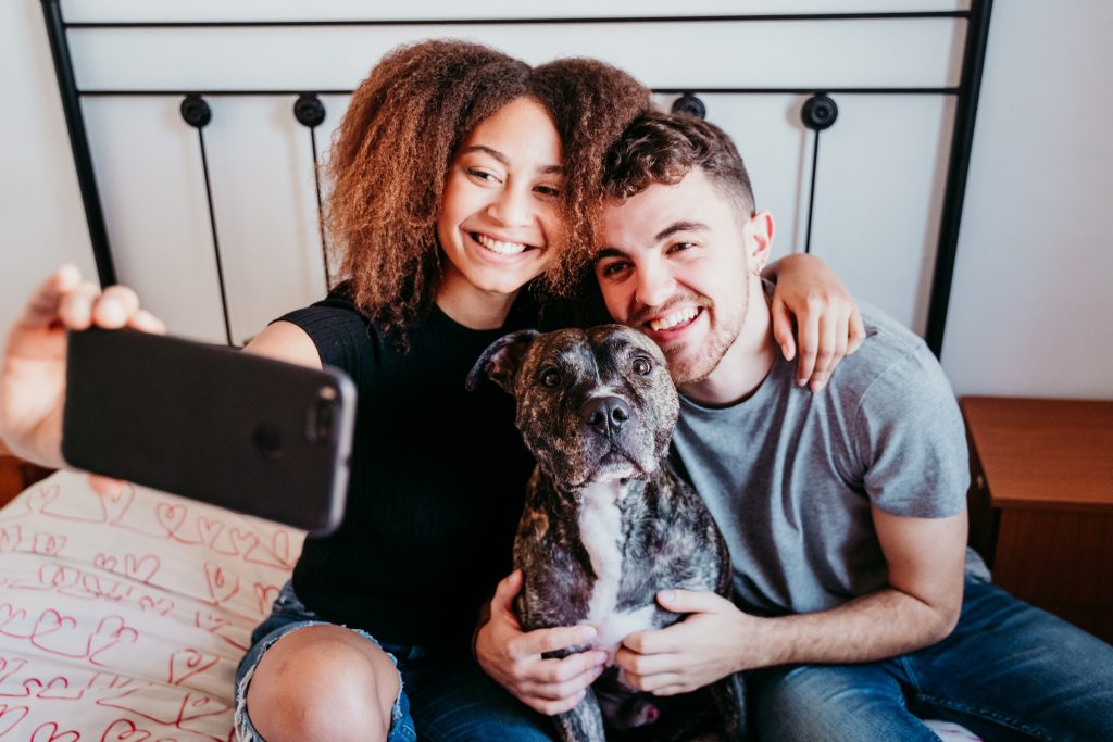 Millennial & Gen Z pet owners taking a selfie with their dog