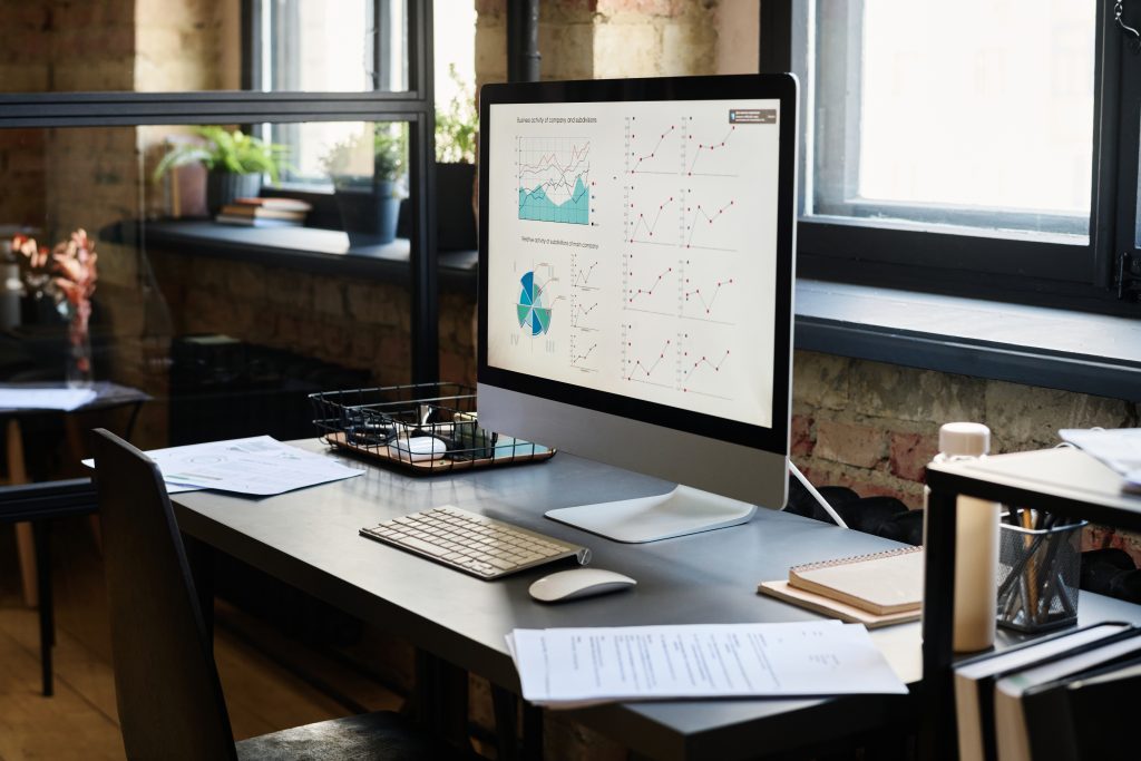 Desktop computer showing local SEO analytics and performance charts for financial services marketing